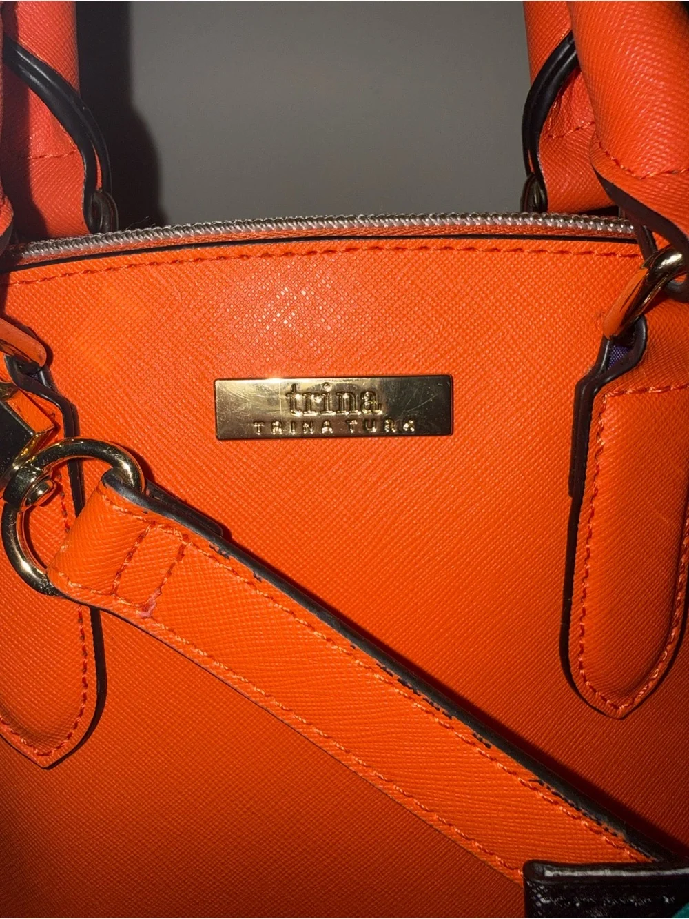 Trina Turk Dome Satchel Handbag in a vibrant, sunset orange.